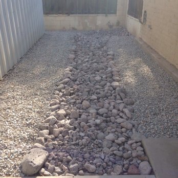 French drain rock channel installation by Brainard's Greenscapes
