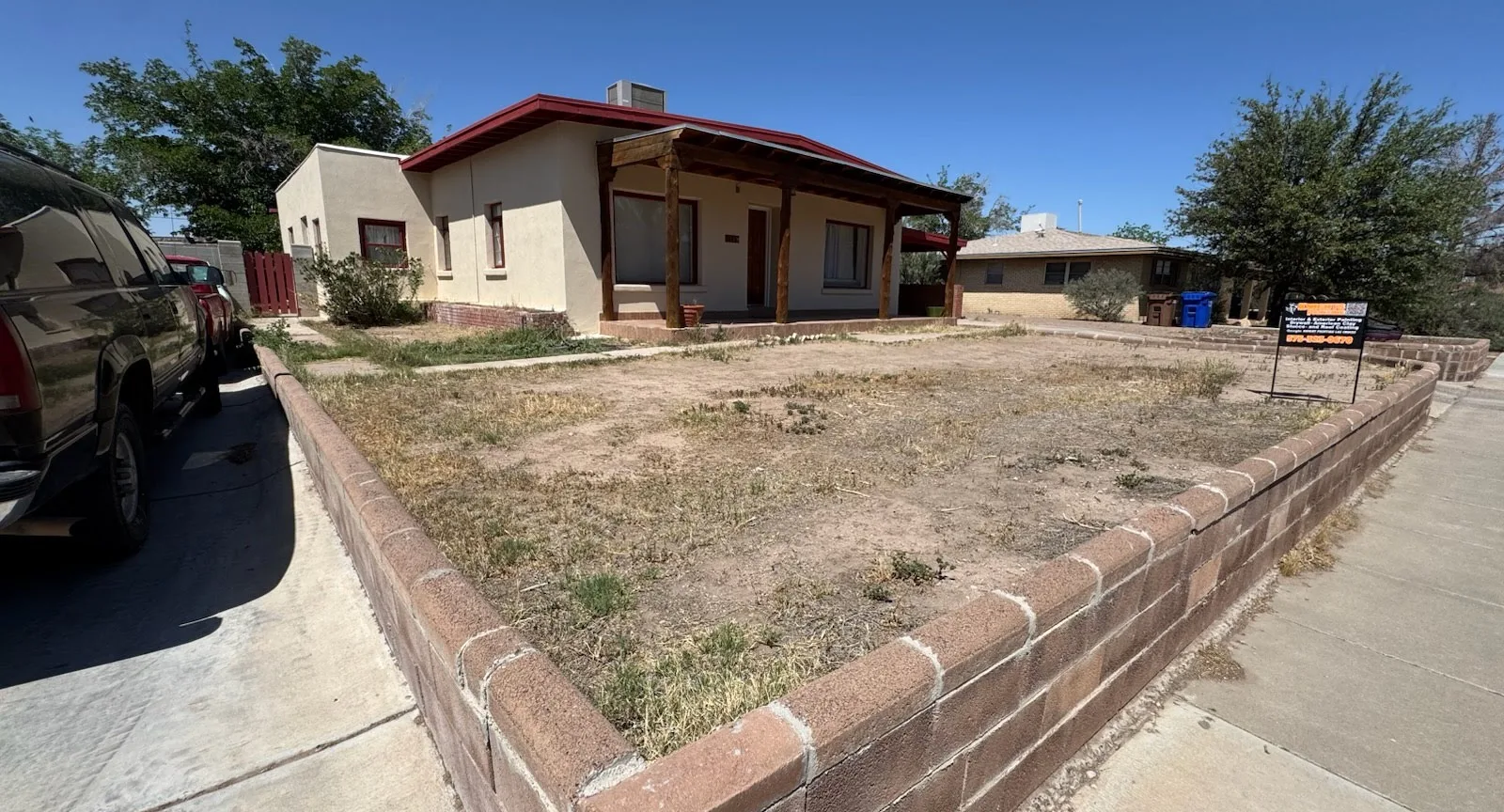 Before: bare front yard with weeds and patchy dirt
