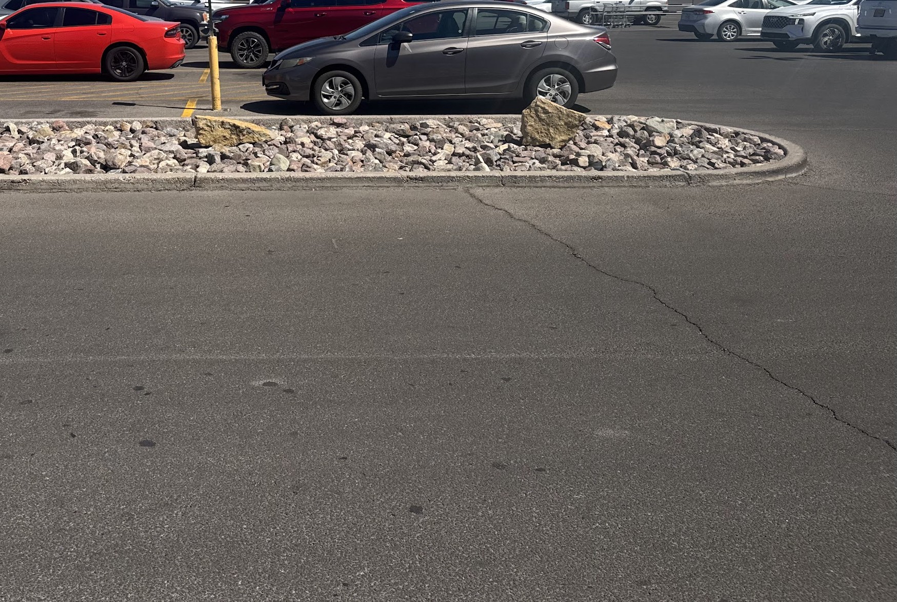After: commercial curb island with fresh rock and clean edging