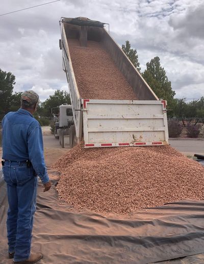 Bulk decorative gravel delivery on site for a Las Cruces landscaping project