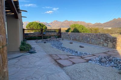 Flagstone patio with dry creek bed and gravel xeriscape overlooking the Organ Mountains