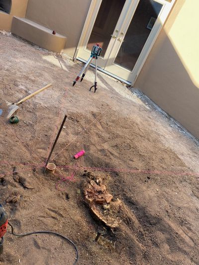 Laser level and string lines laying out a new flagstone patio base in a Las Cruces courtyard